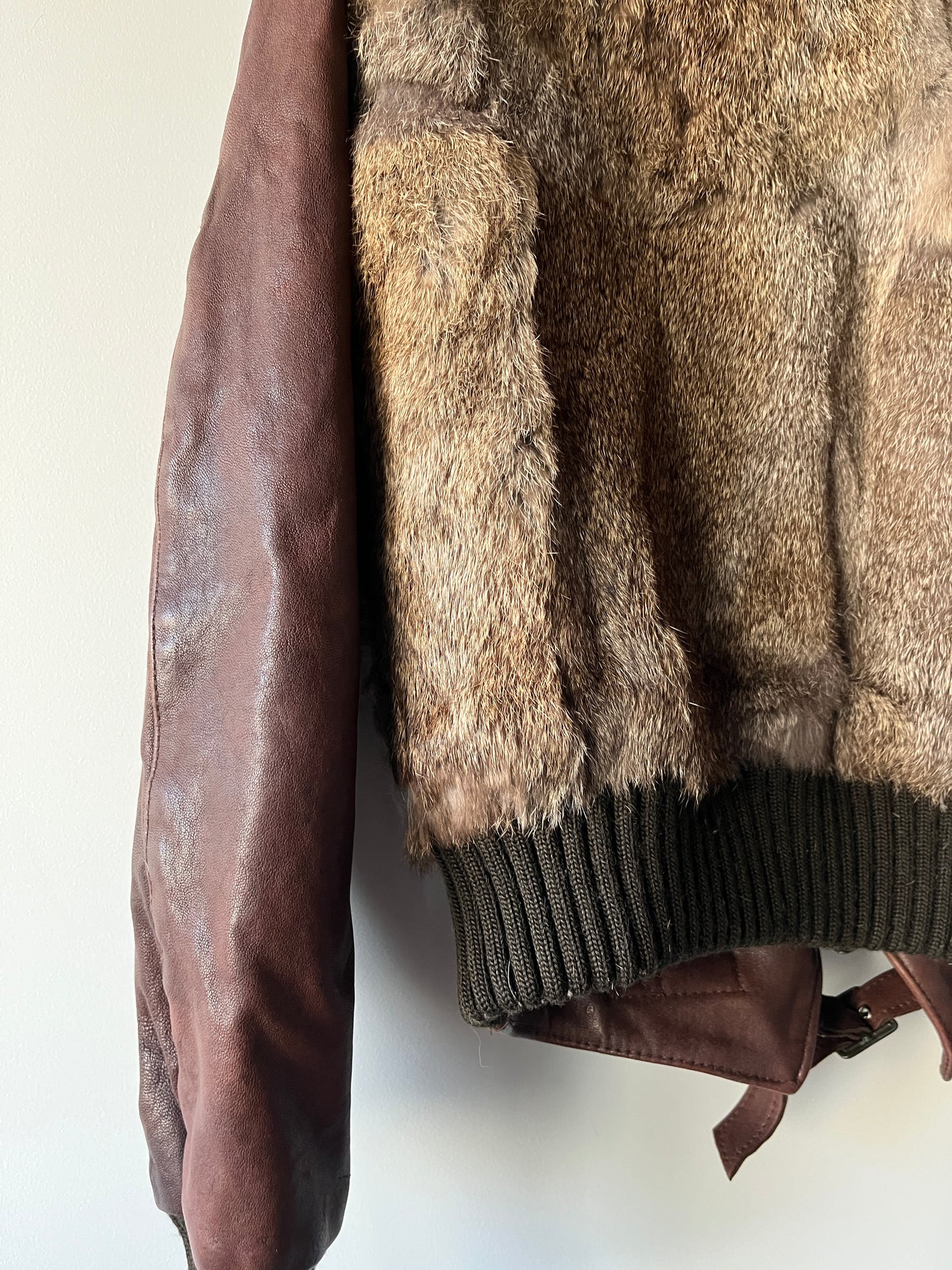 Veste courte en fourrure et cuir à boucles