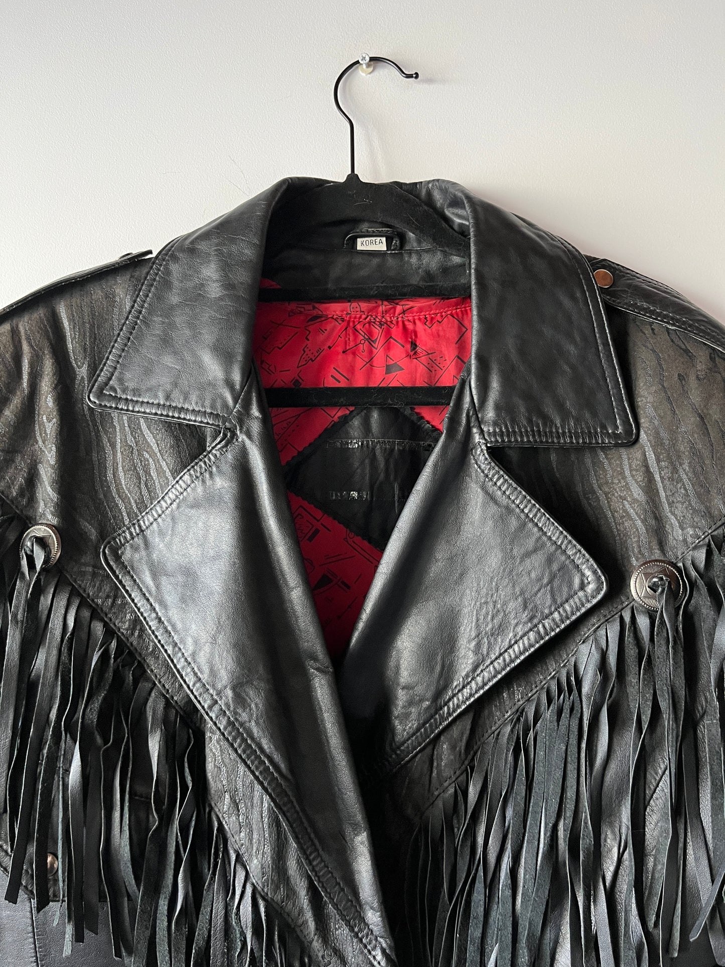 Veste en cuir noire à franges
