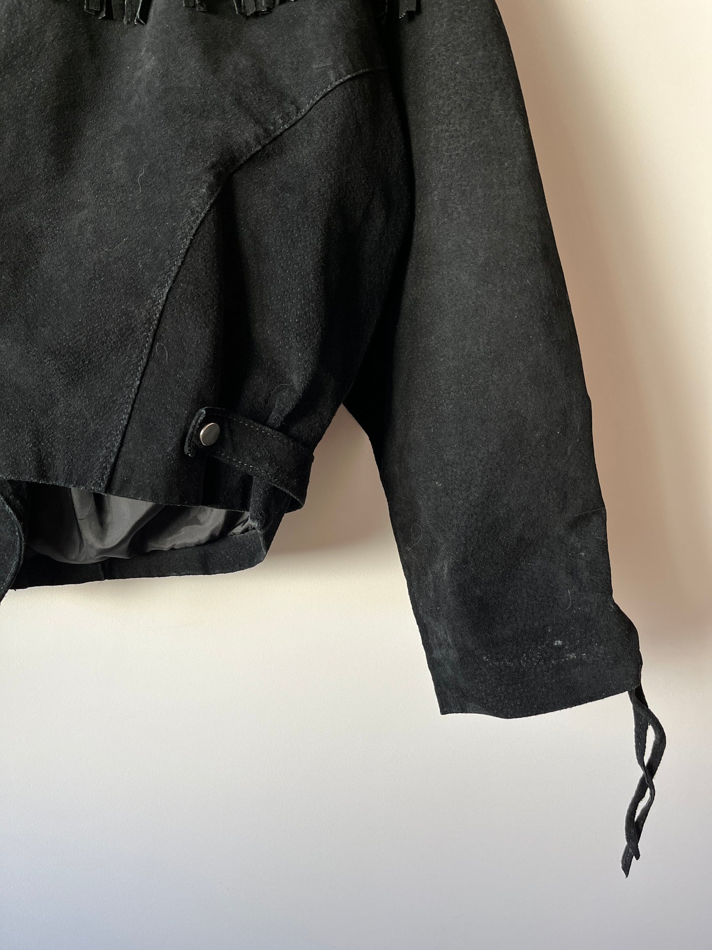 Veste en cuir noire à franges