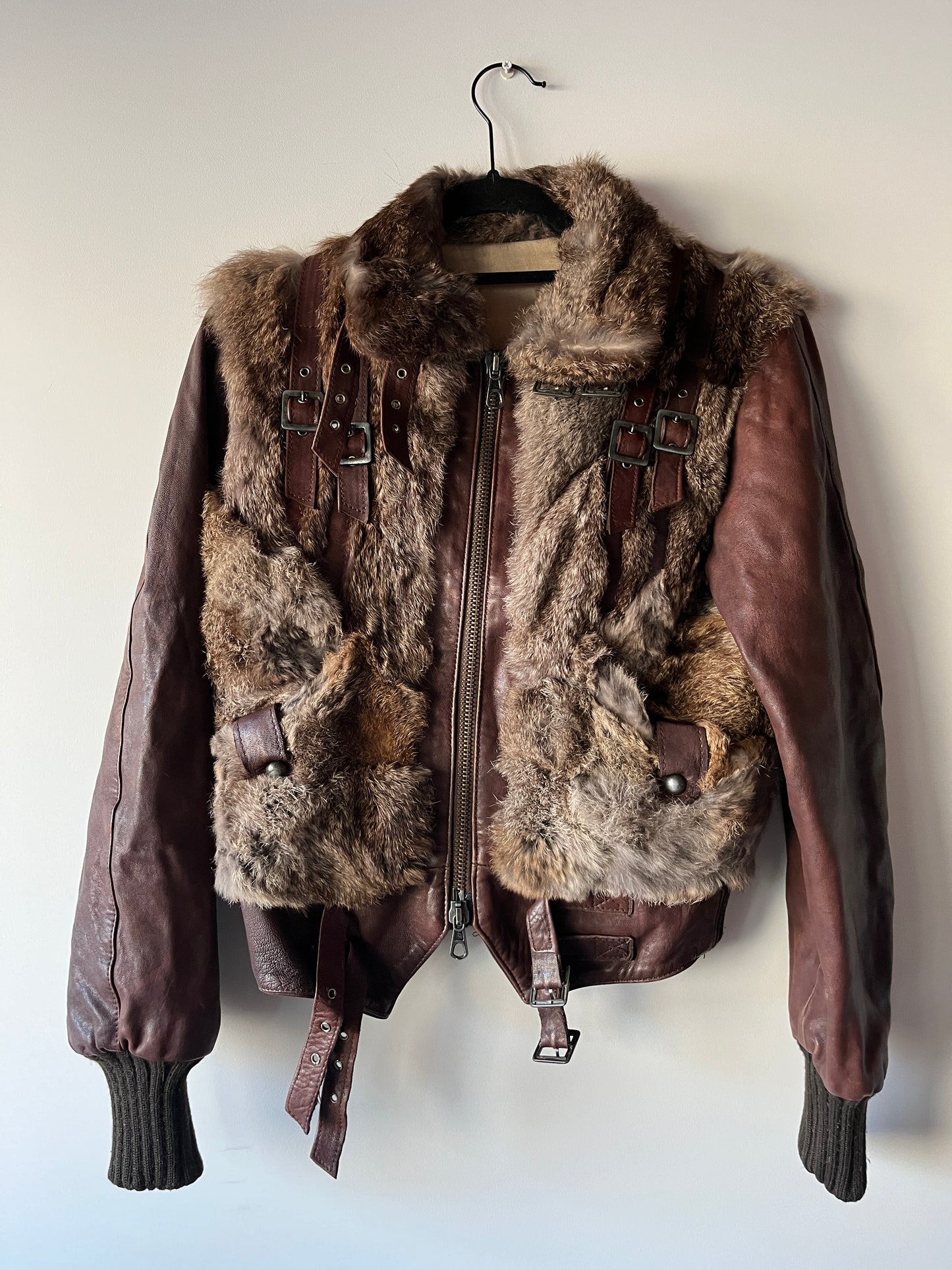 Veste courte en fourrure et cuir à boucles