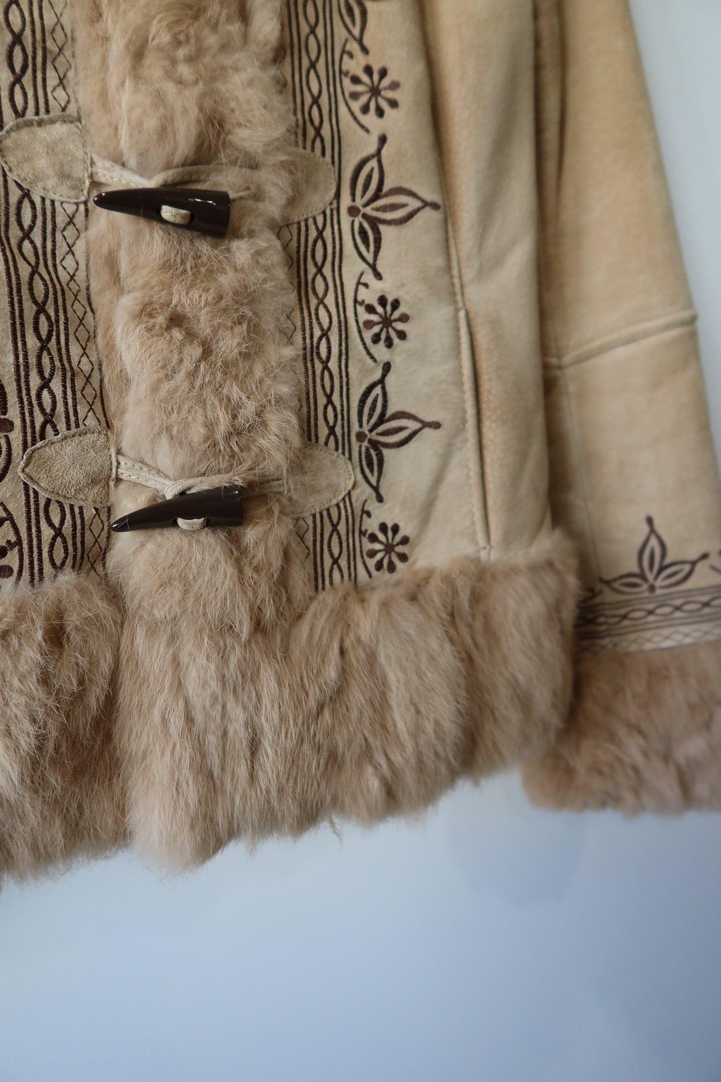 Veste en peau retournée beige et bordures en fourrure