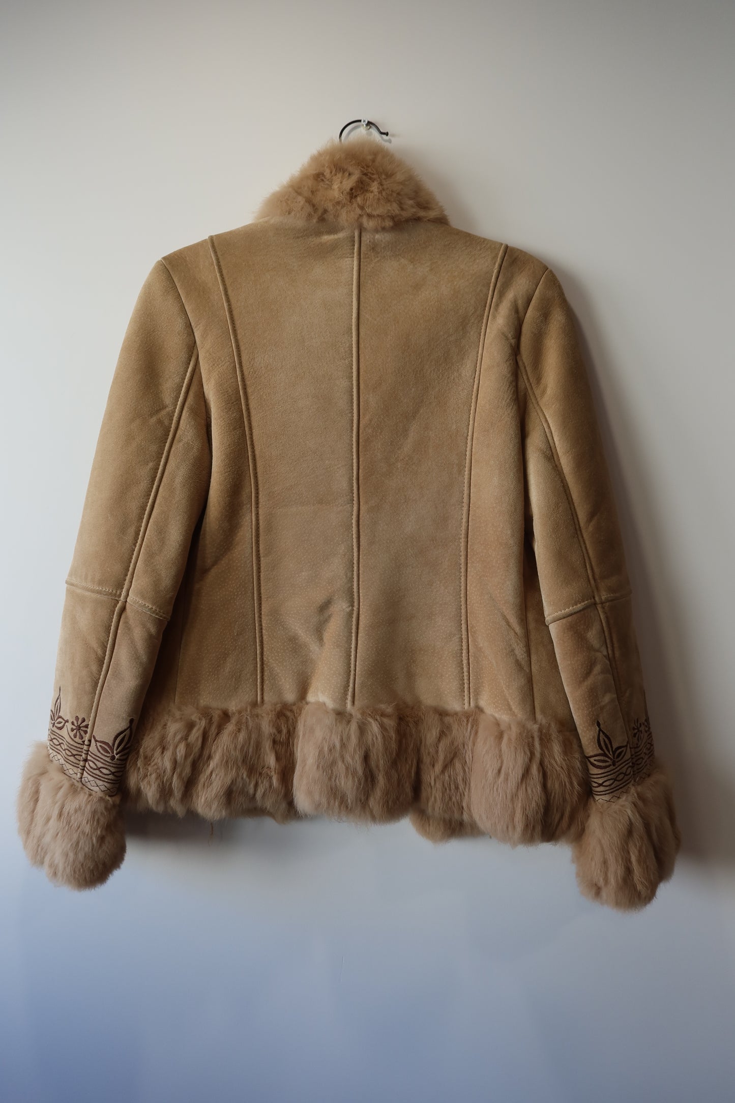Veste en peau retournée beige et bordures en fourrure