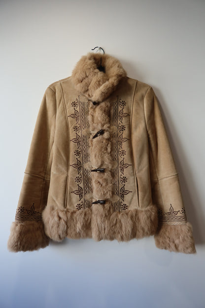Veste en peau retournée beige et bordures en fourrure